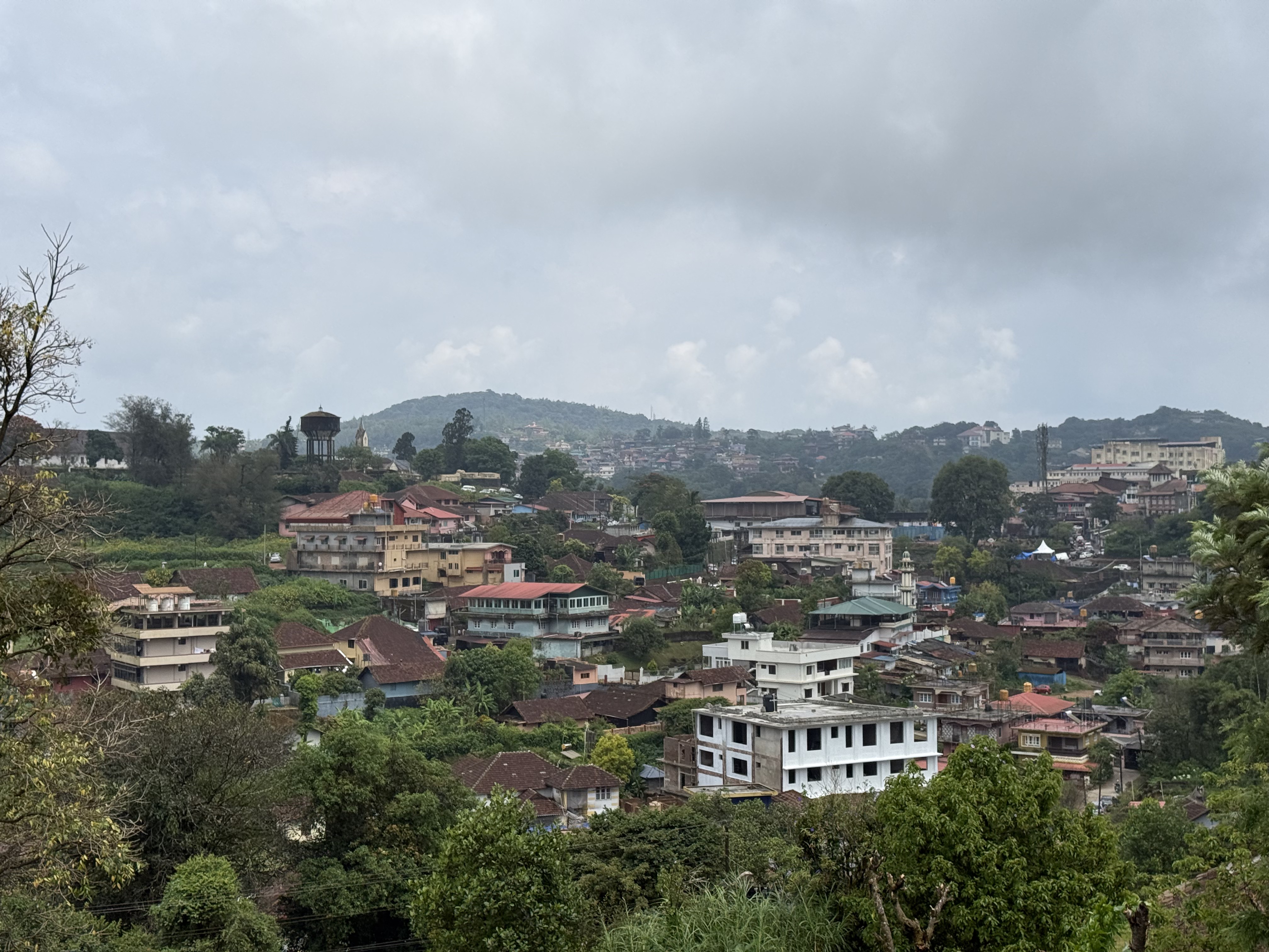 Hillside town beneath monsoon clouds