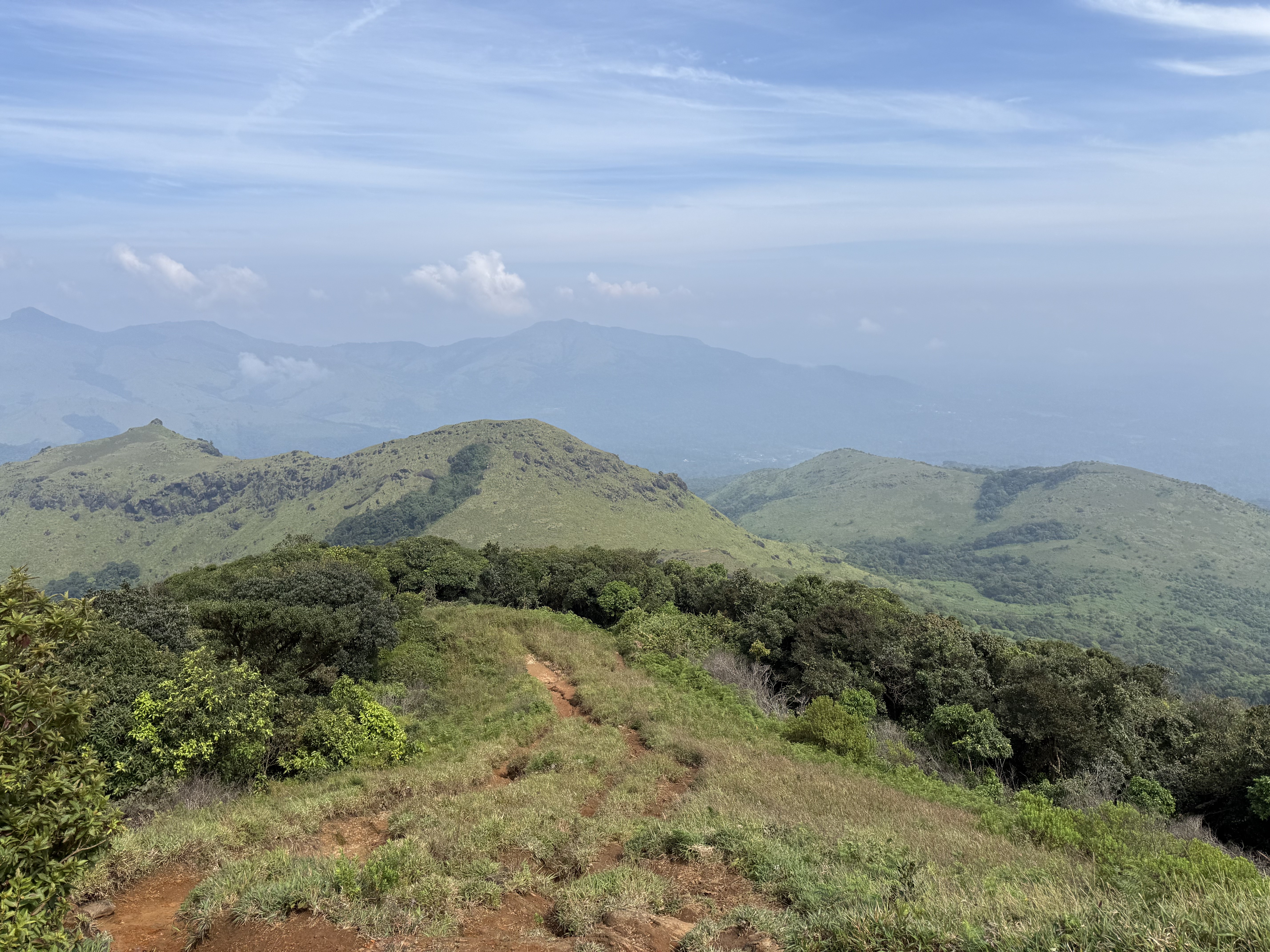 Trail descending through green hills